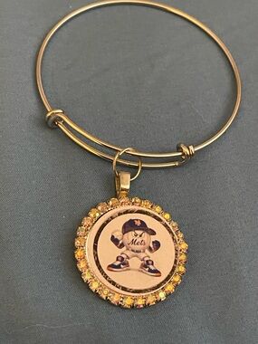 Gold-Tone Mets Logo Crystal Pendant Bangle Bracelet